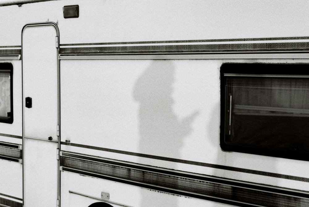 a shadow of a person standing in front of a trailer