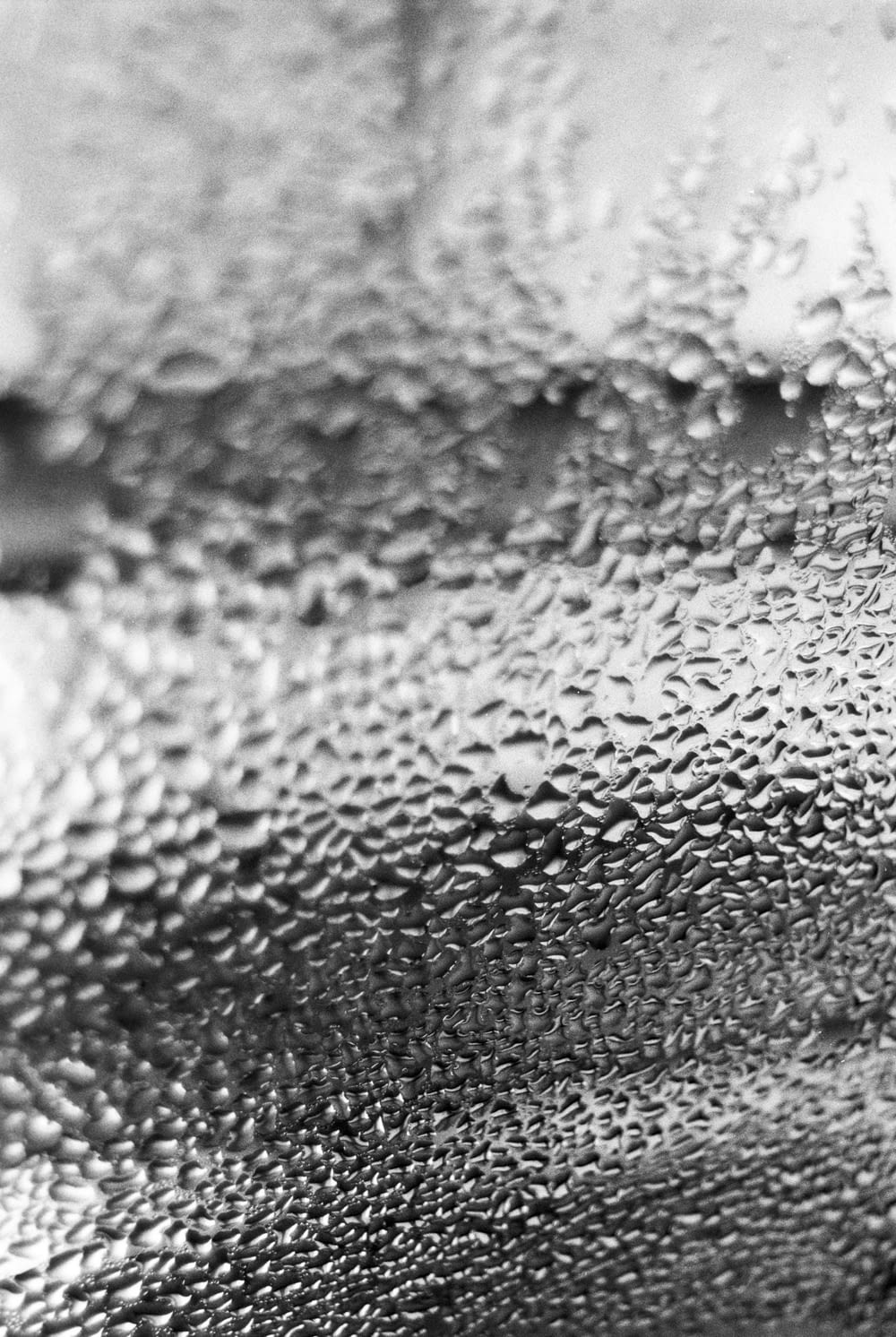 a black and white photo of water droplets