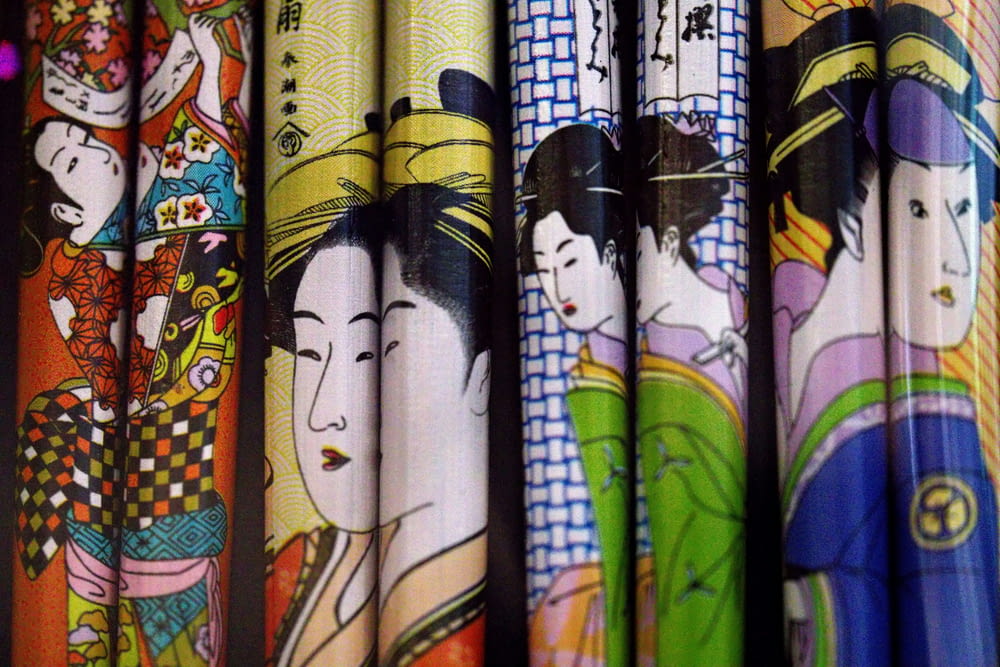 a row of colorful umbrellas with asian characters on them