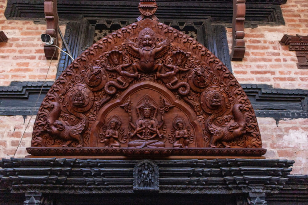 an ornate wooden carving on the side of a building