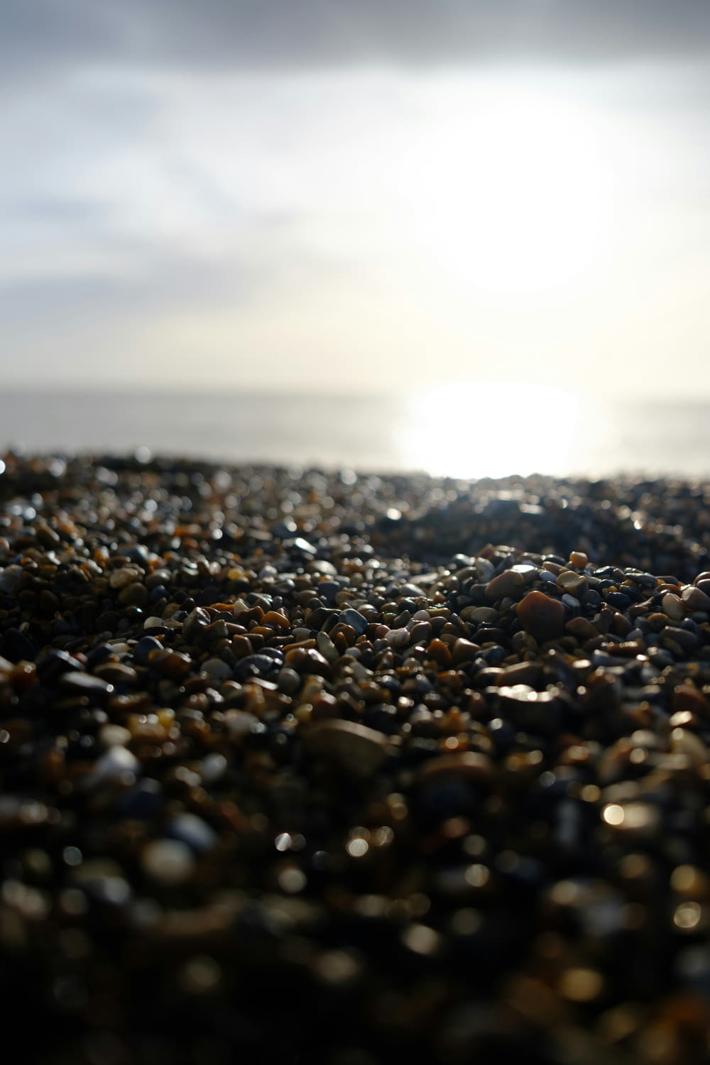 a close up of a beach with rocks and water