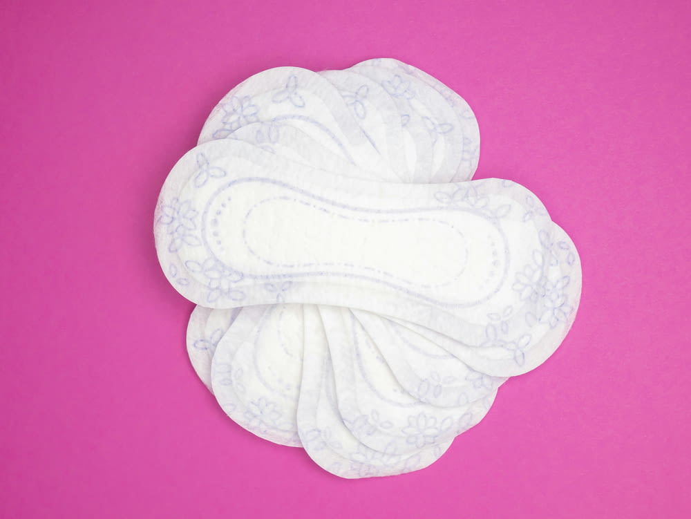 a close up of a cloth pad on a pink background