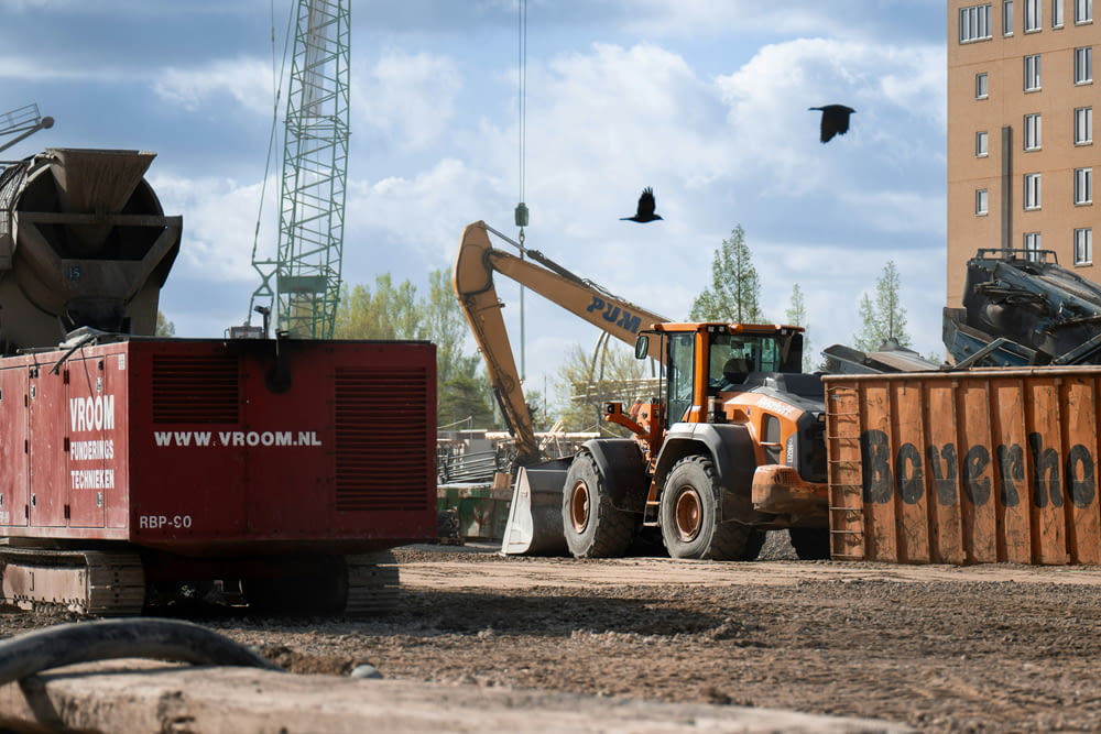 a construction site with a dump truck and a crane