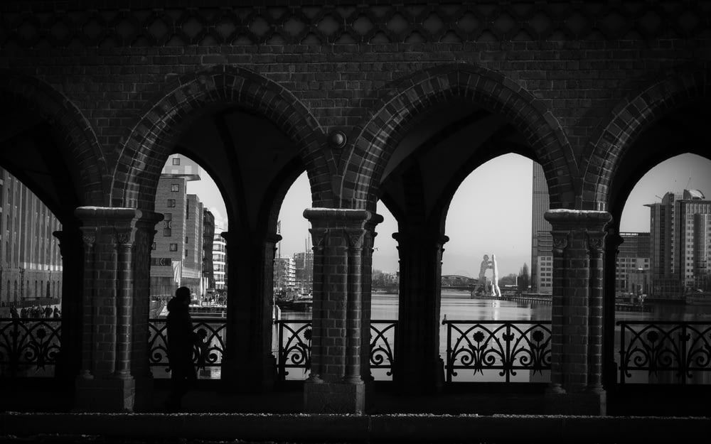 a black and white photo of a person looking out over a city