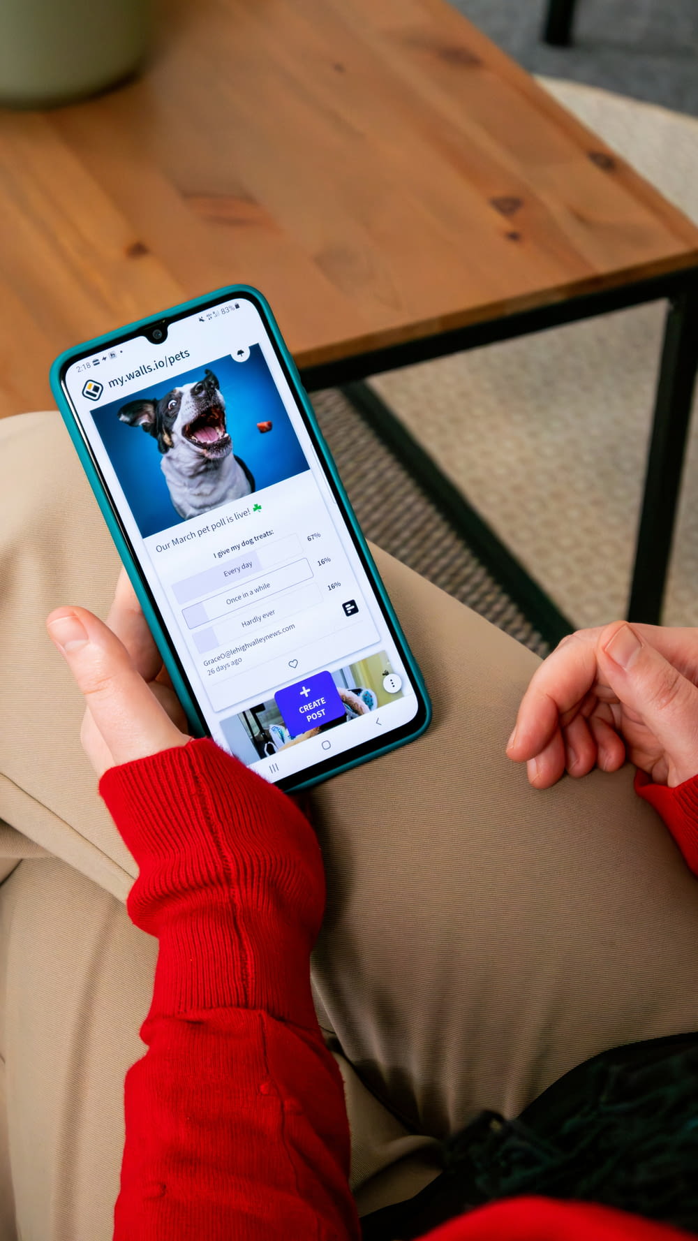 a person holding a cell phone with a dog on the screen