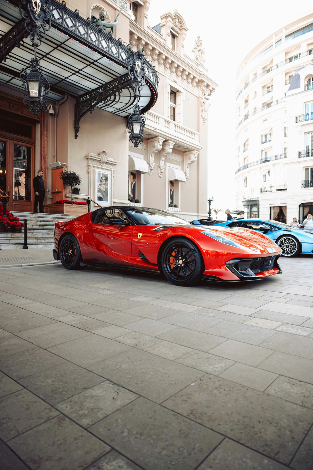 a red sports car parked in front of a building
