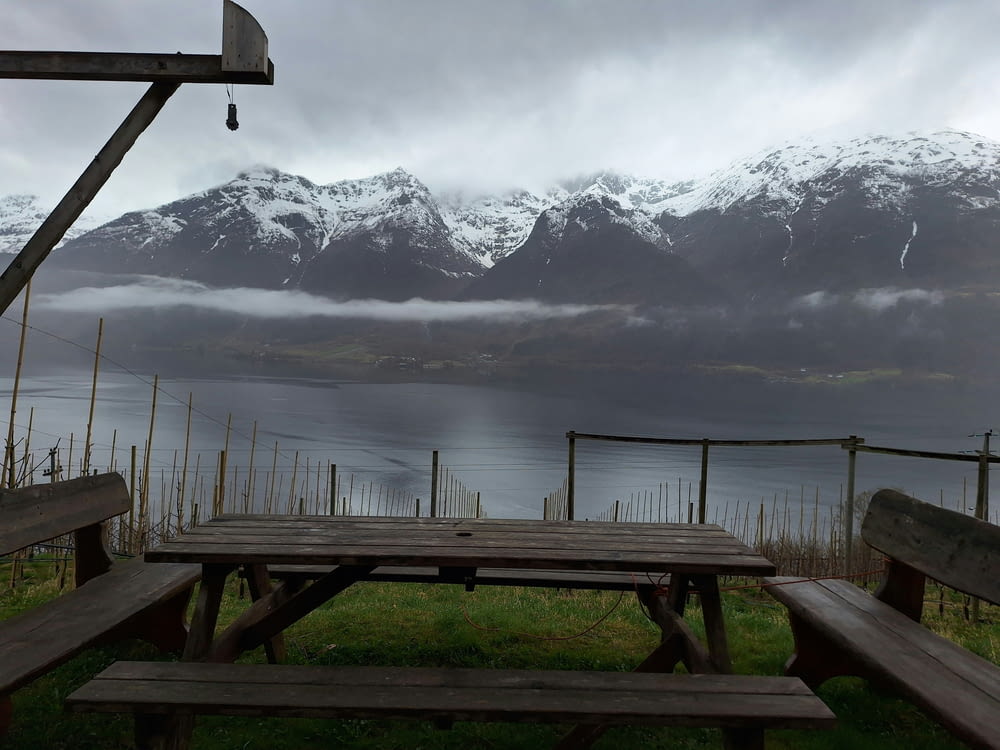a picnic table with a view of a mountain range