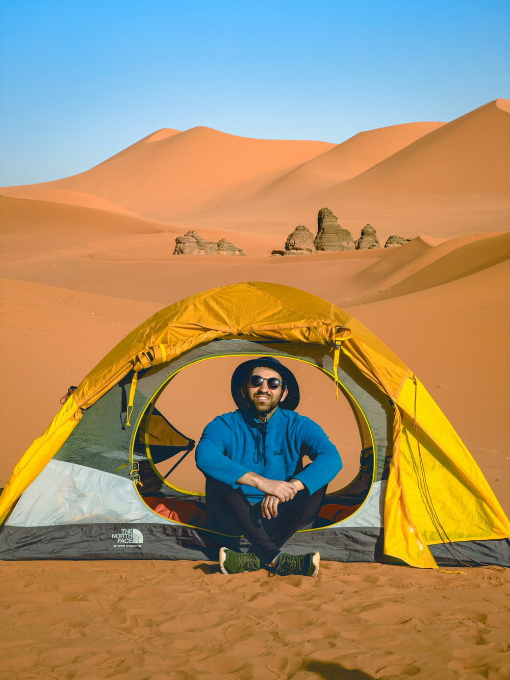 Ein Mann sitzt in einem Zelt in der Wüste