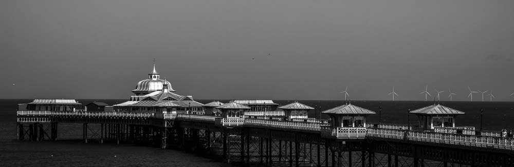 a black and white photo of a pier