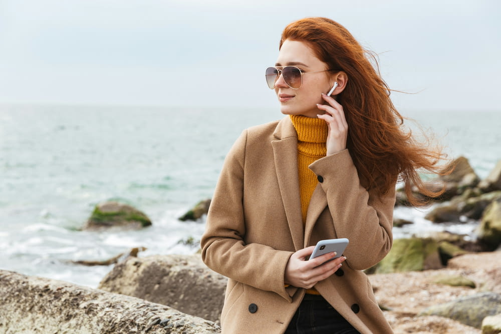 a woman with red hair talking on a cell phone