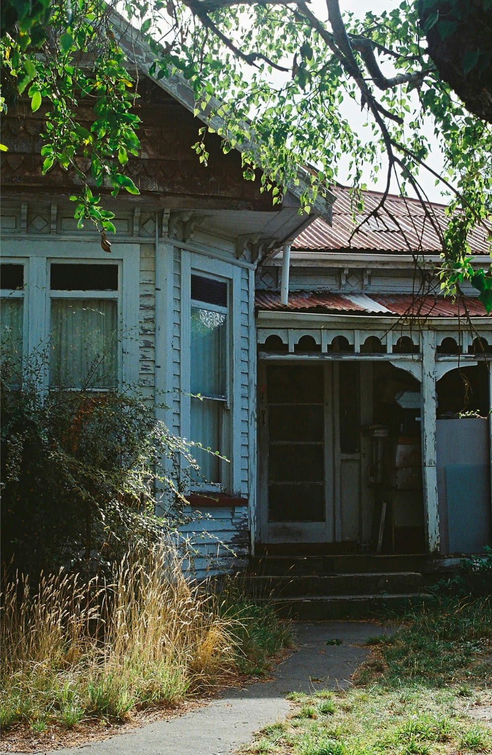 an old run down house with a broken door
