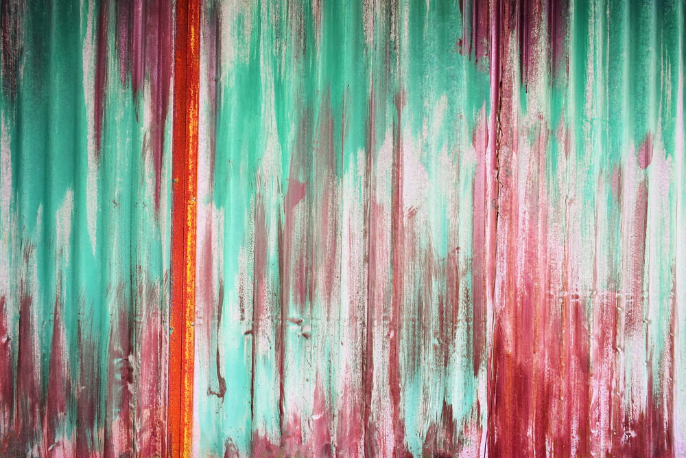 an abstract painting with red and green colors