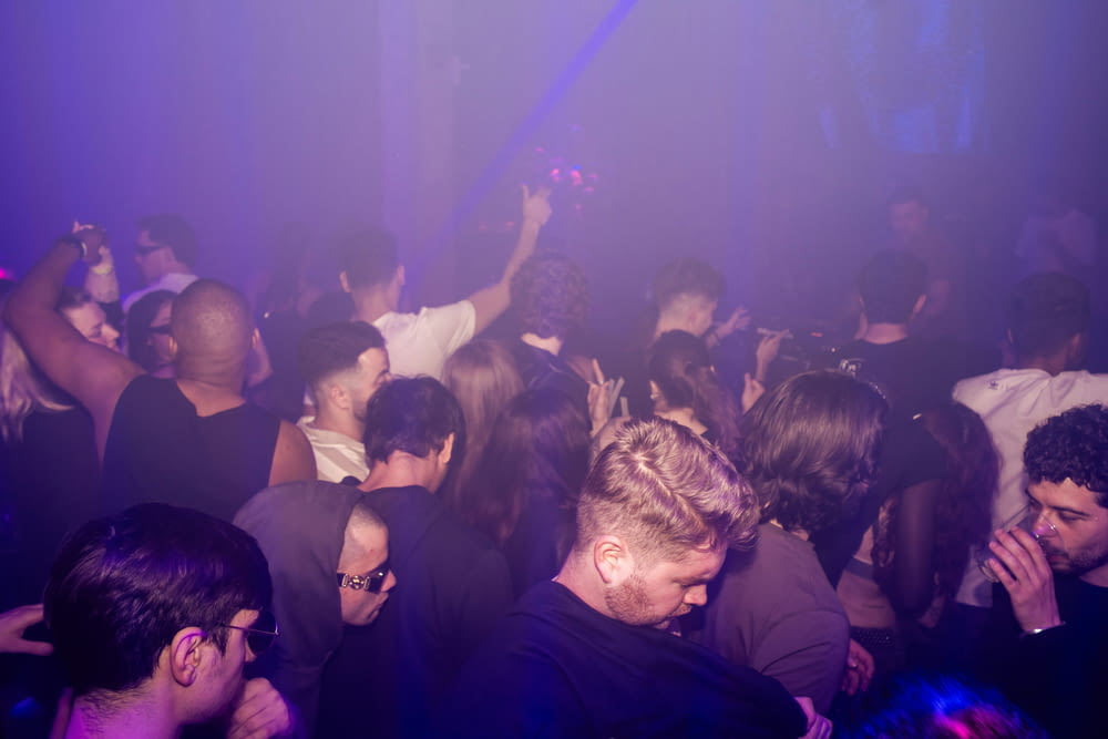 a crowd of people standing around a nightclub