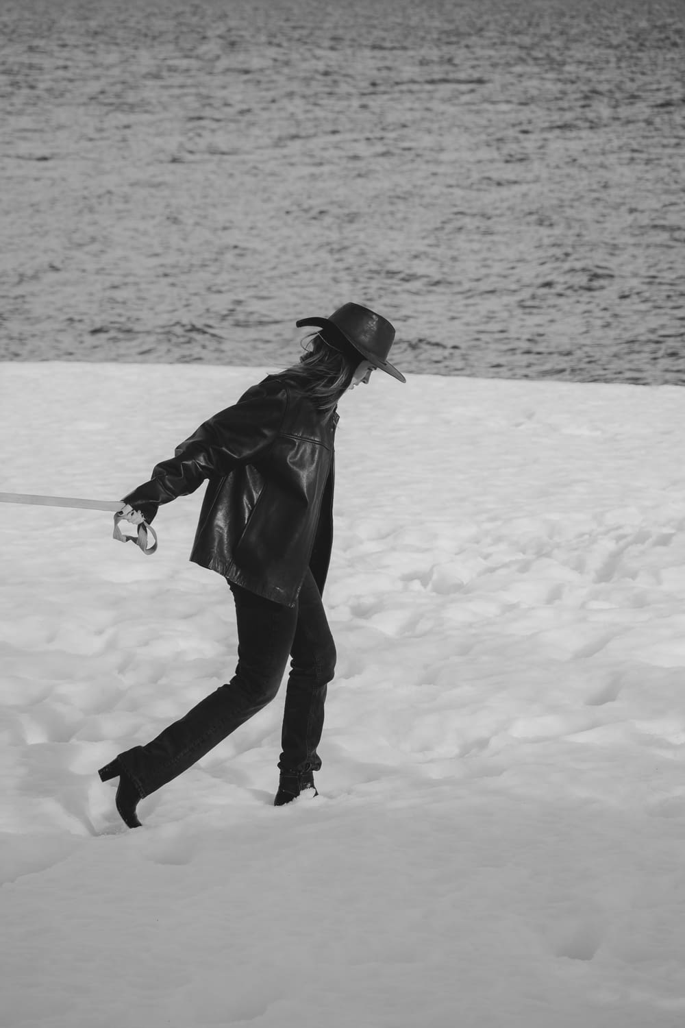 a woman walking across a snow covered field