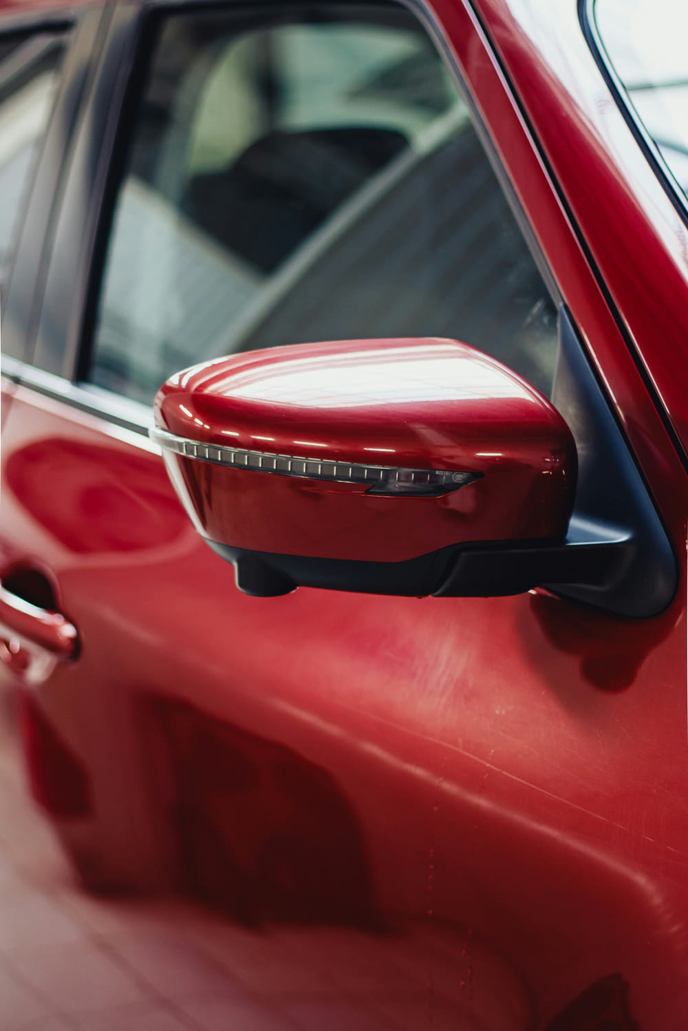 a close up of a red car door handle