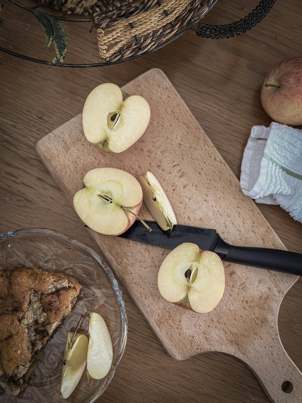 a cutting board topped with sliced apples next to a knife