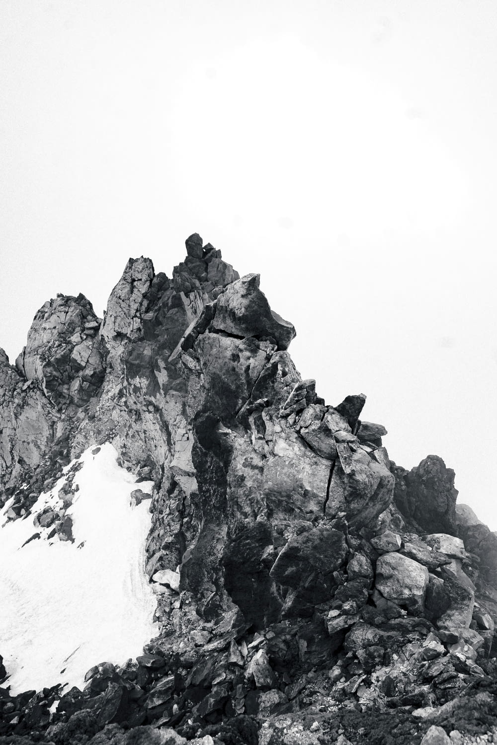 a black and white photo of a mountain peak