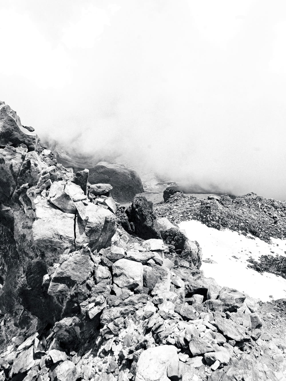 a black and white photo of a person on a mountain