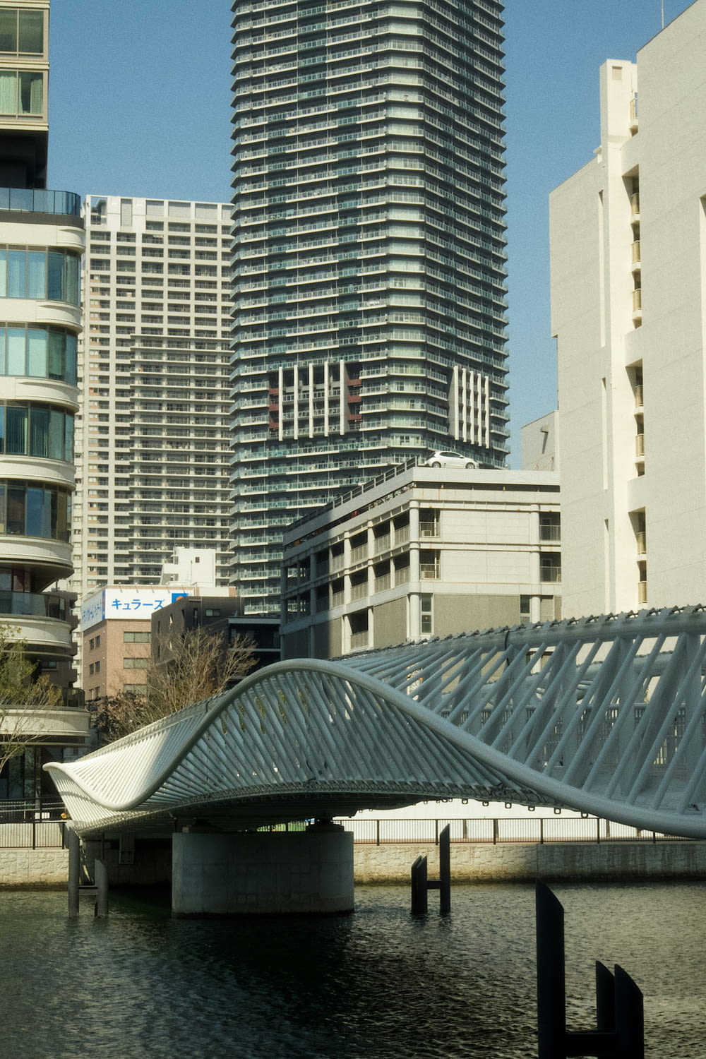 a bridge over a body of water in front of tall buildings