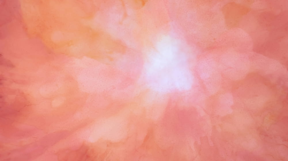 a pink and orange background with a white center