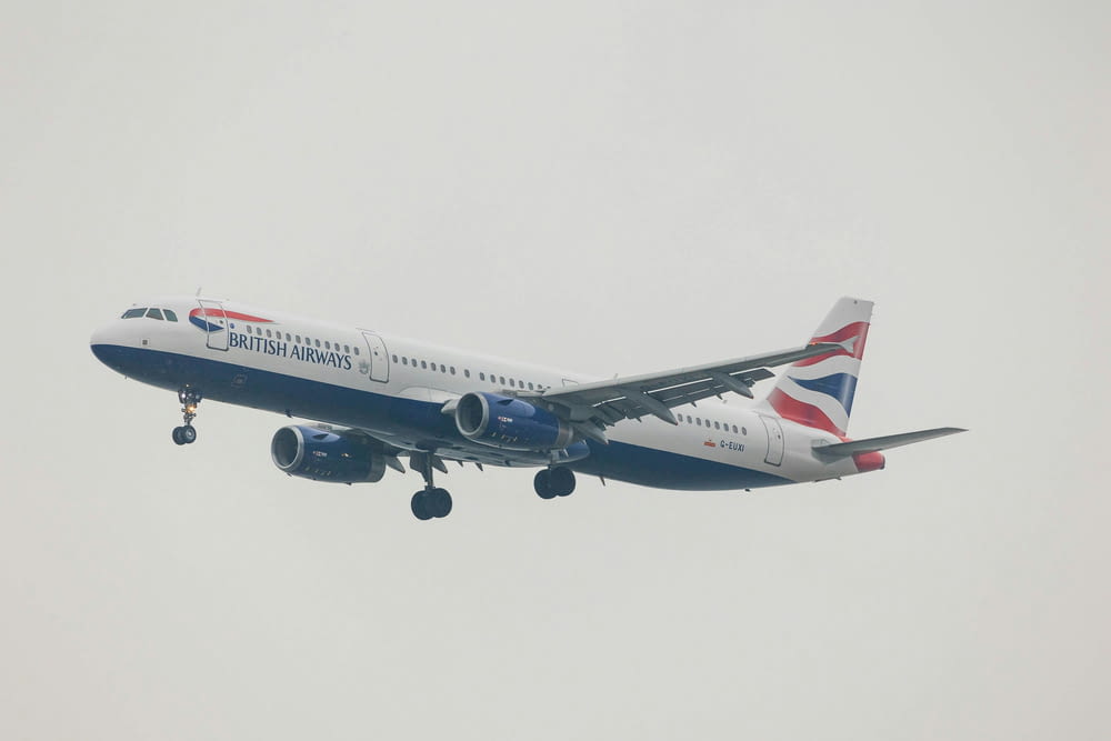 a large passenger jet flying through a gray sky