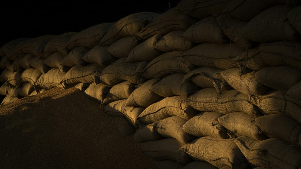 a pile of sand sitting next to a pile of bags