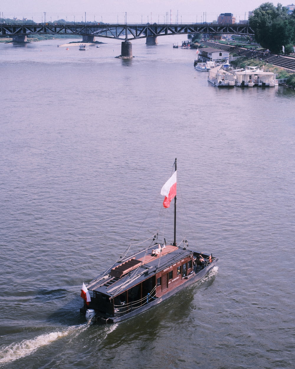 a small boat with a canadian flag on it in the water