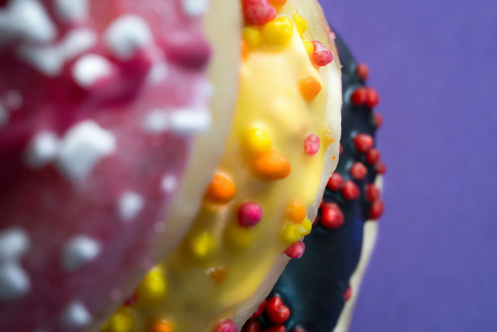 a close up of a three layer cake with sprinkles