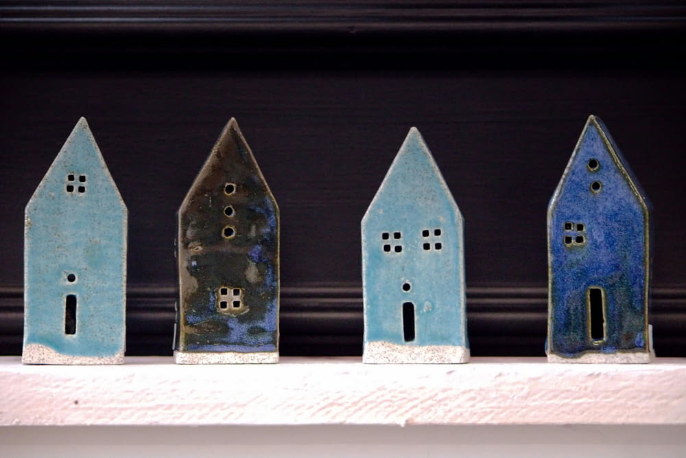 a row of small houses sitting on top of a shelf