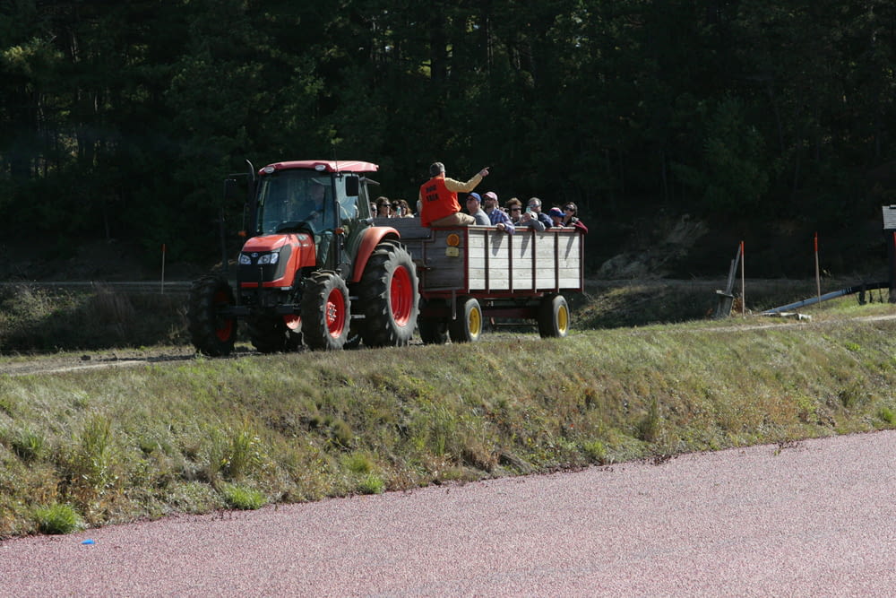 a tractor pulling a trailer filled with people