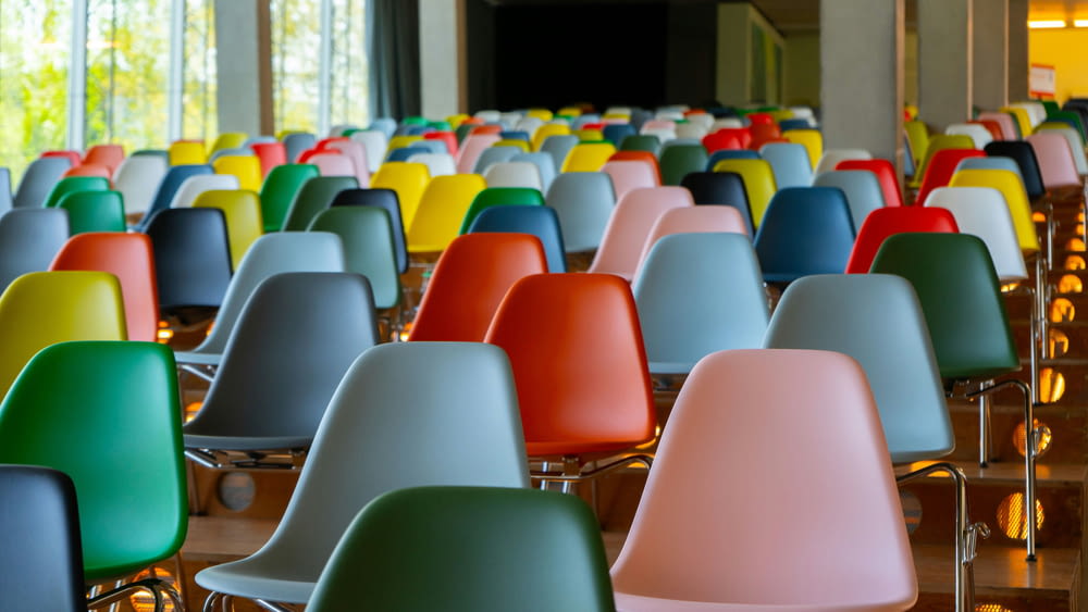a room filled with lots of colorful chairs