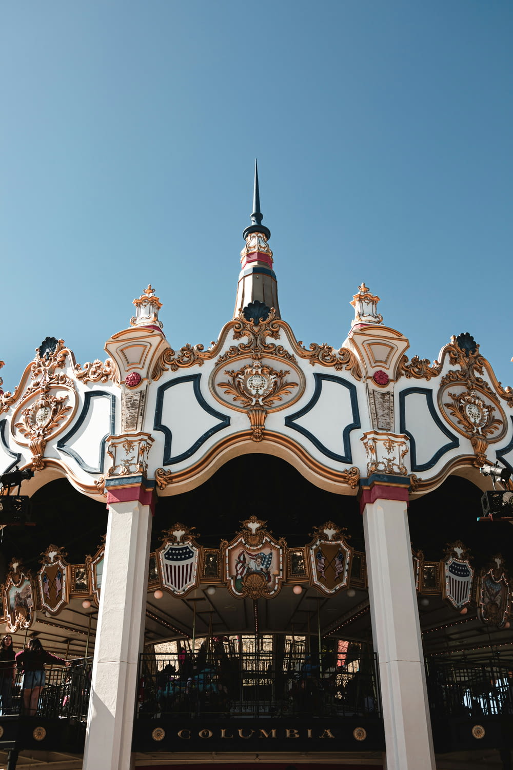 a merry go round with a clock on top of it