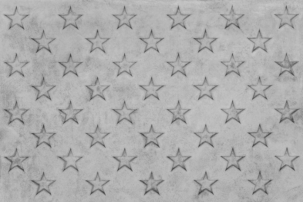 a black and white photo of stars on a wall