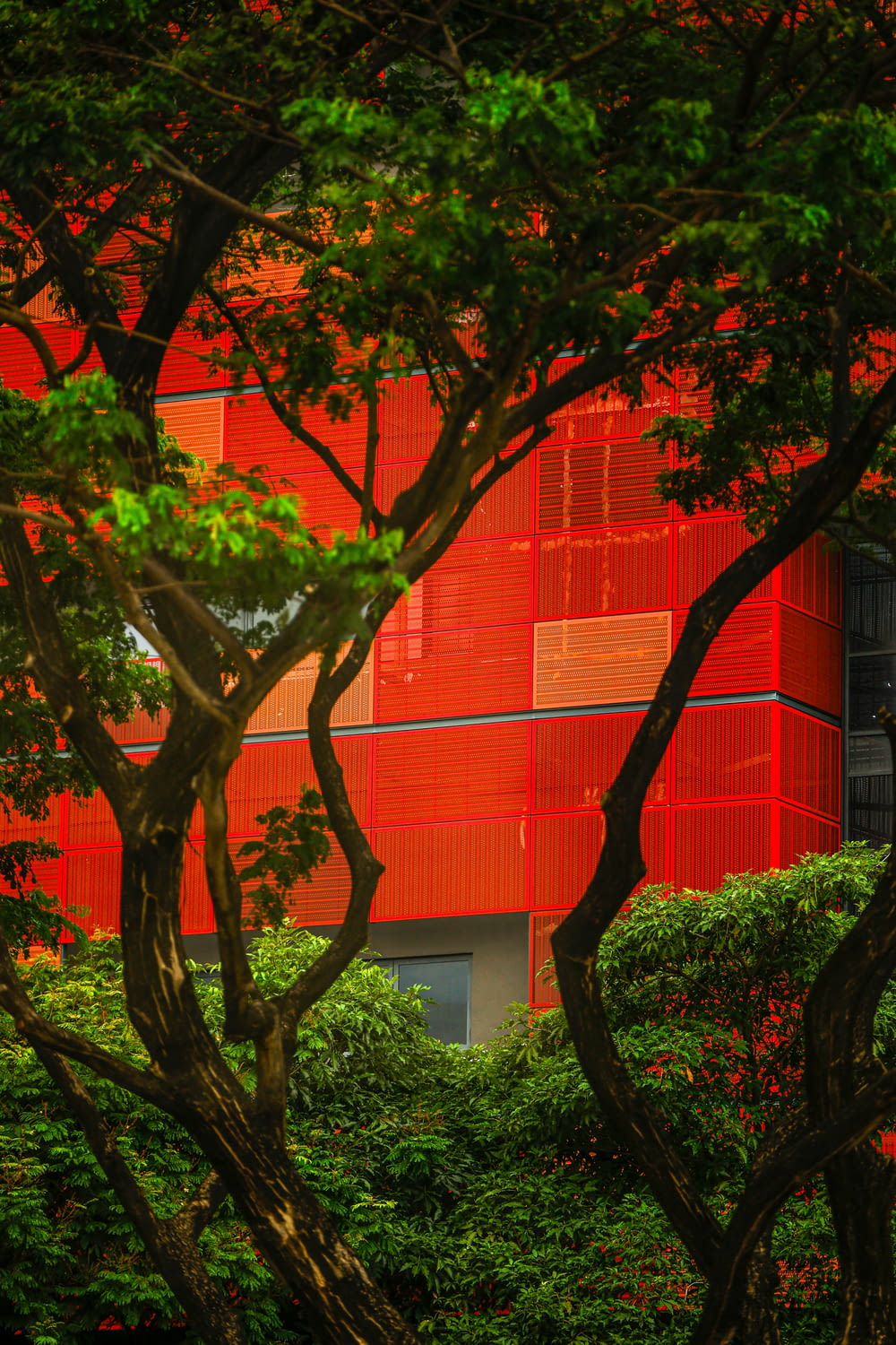 a red building with trees in front of it
