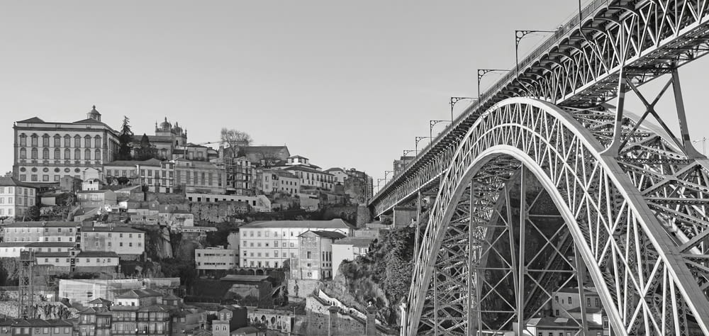 a black and white photo of a bridge and a city