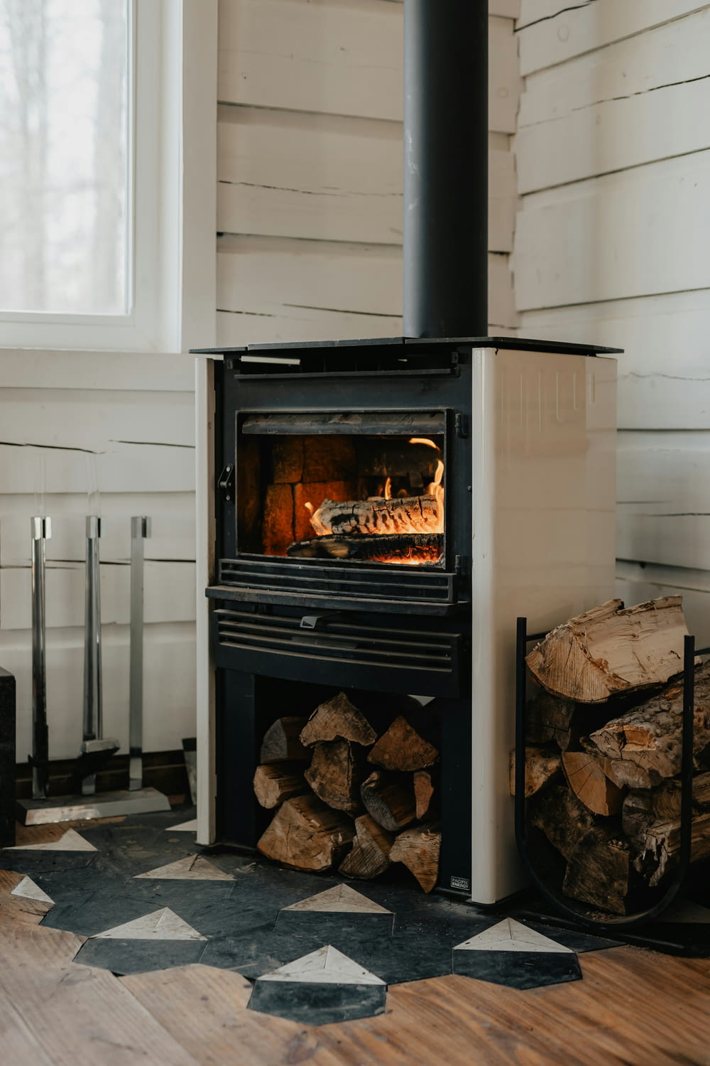 a wood burning stove in a room with a checkered floor