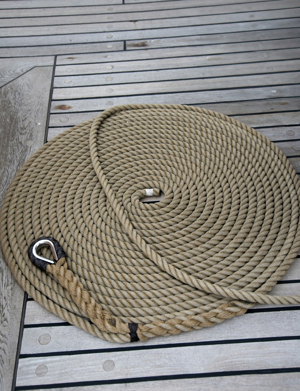 a close up of a rope on a wooden floor