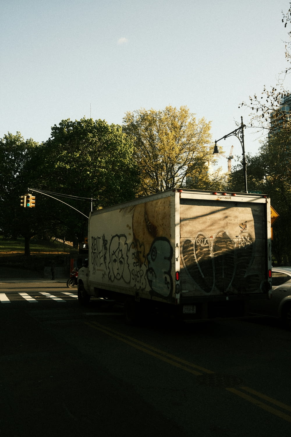 a truck with graffiti driving down a street