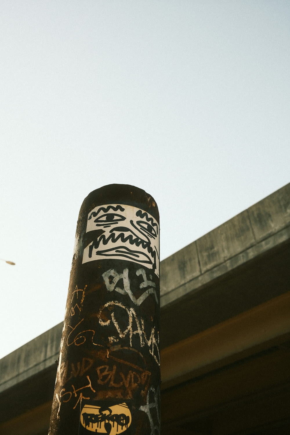 a close up of a pole with graffiti on it