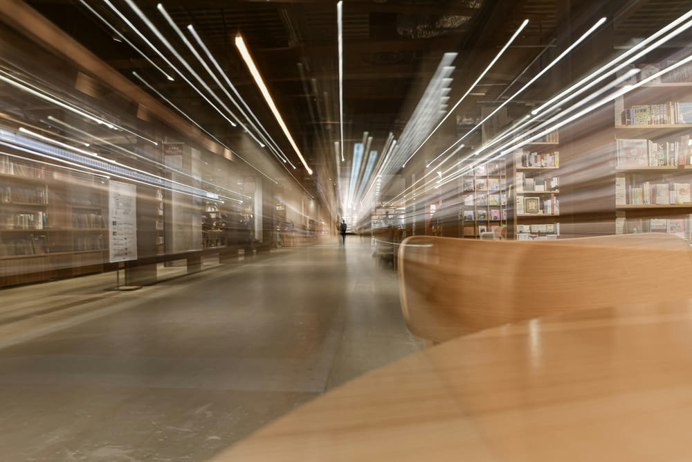 a blurry photo of a library with bookshelves