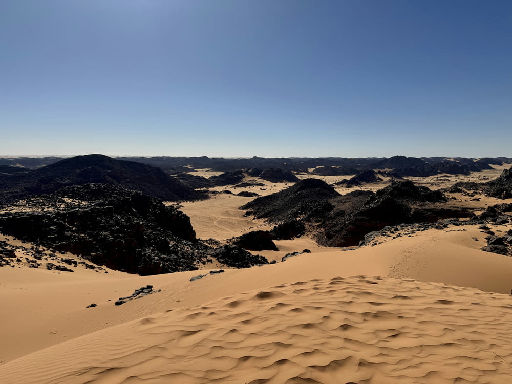 a desert landscape with sand dunes and mountains