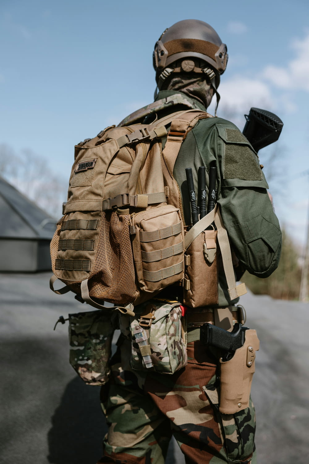a man in camouflage with a backpack on his back