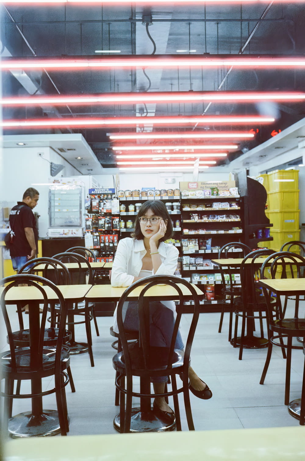 a woman sitting at a table in a store