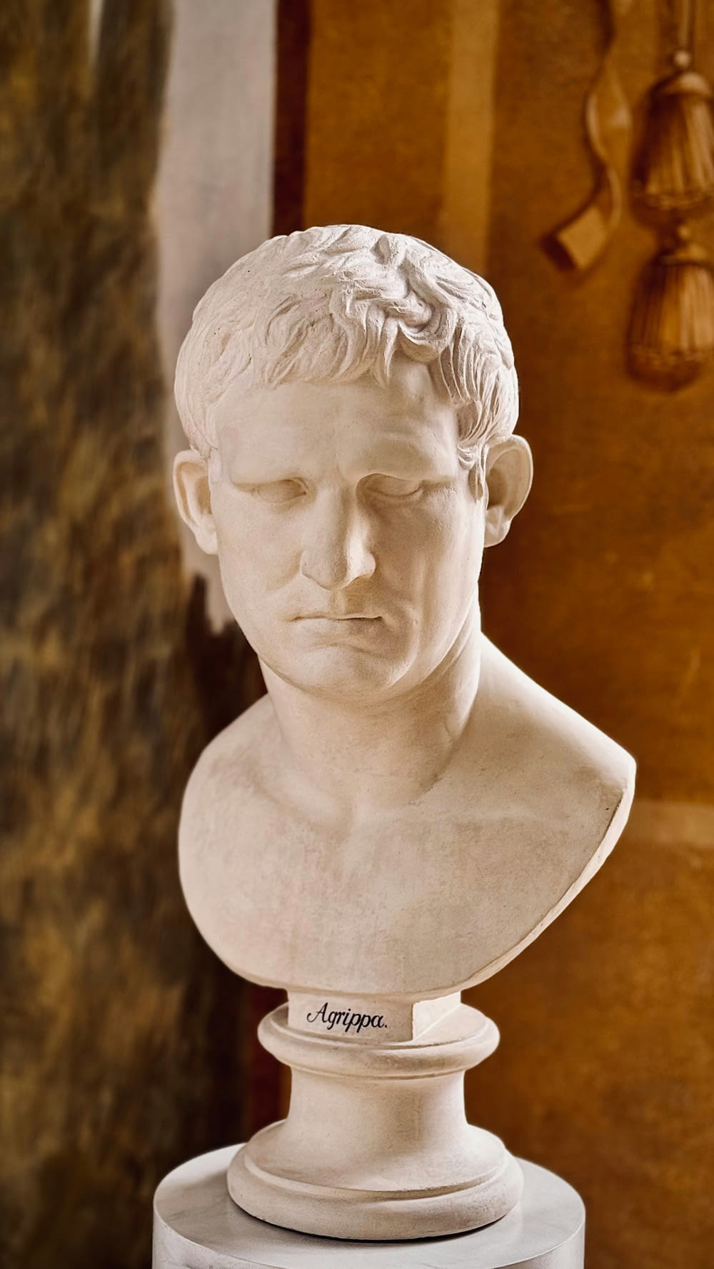 a marble bust of a man with his eyes closed