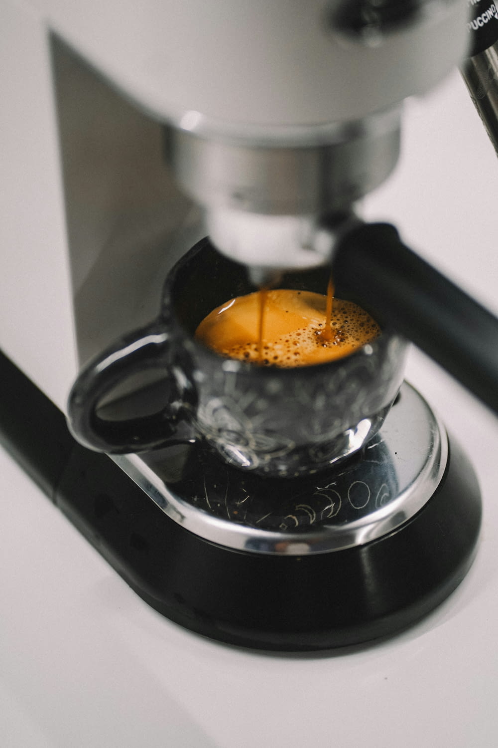 an espresso machine making a cup of coffee