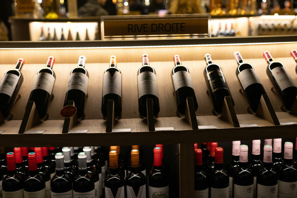 bottles of wine are lined up on a shelf