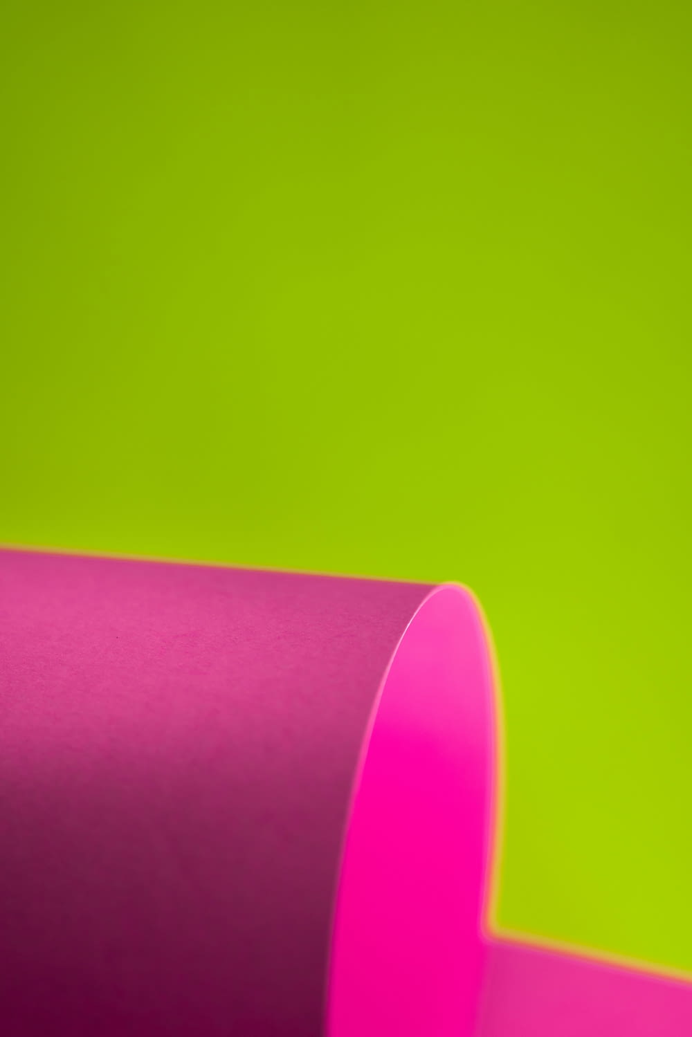 a close up of a pink tube on a green background