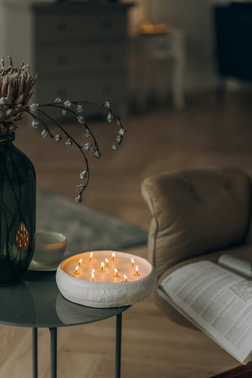 a table with a candle and a book on it