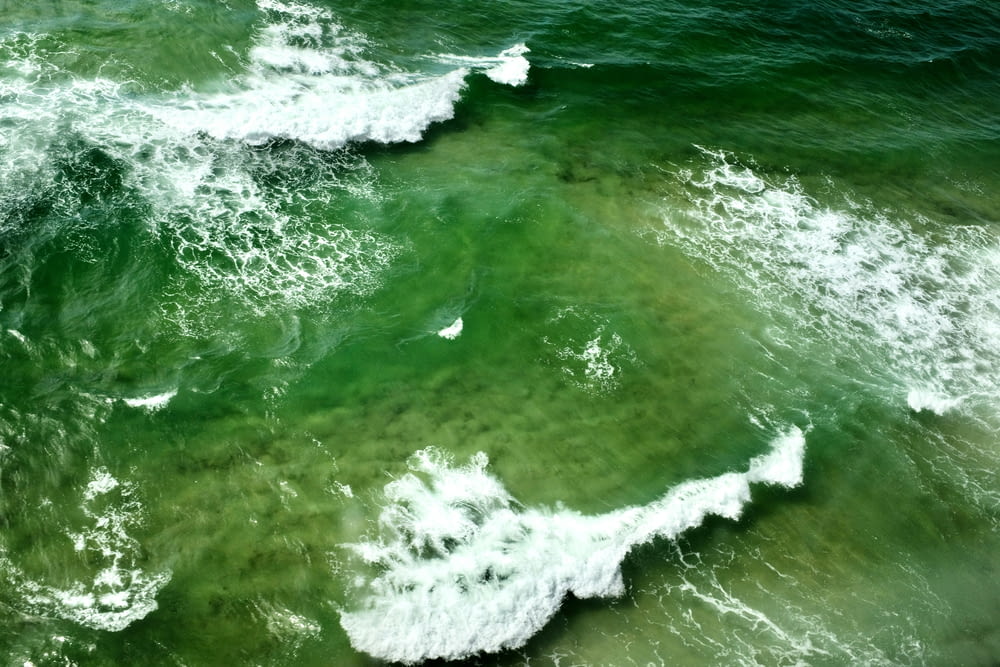 an aerial view of a body of water with waves