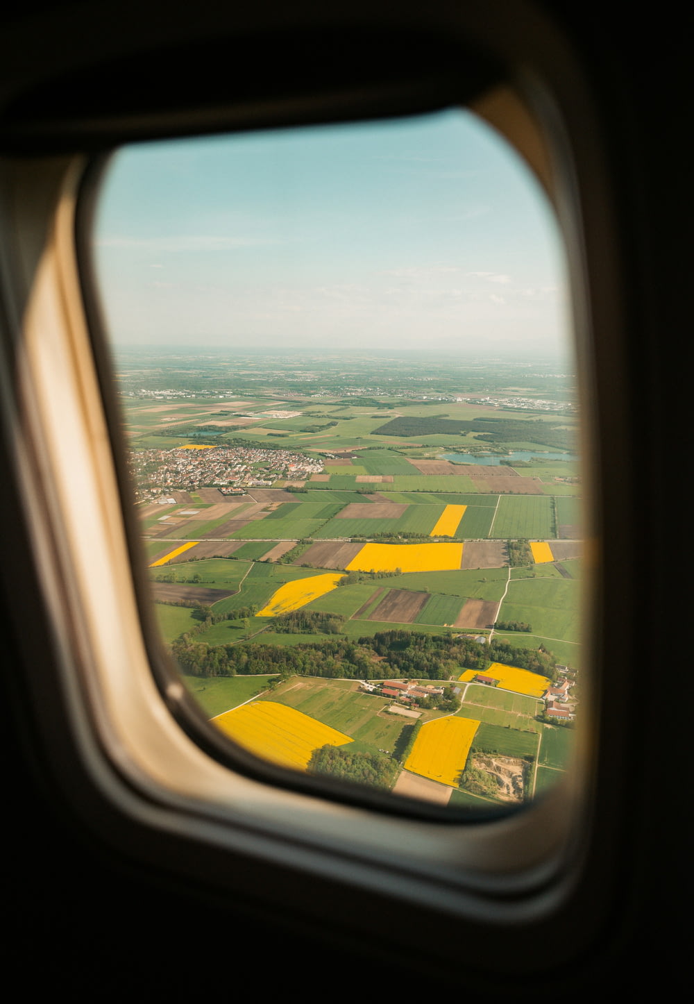 a view of a field from an airplane window